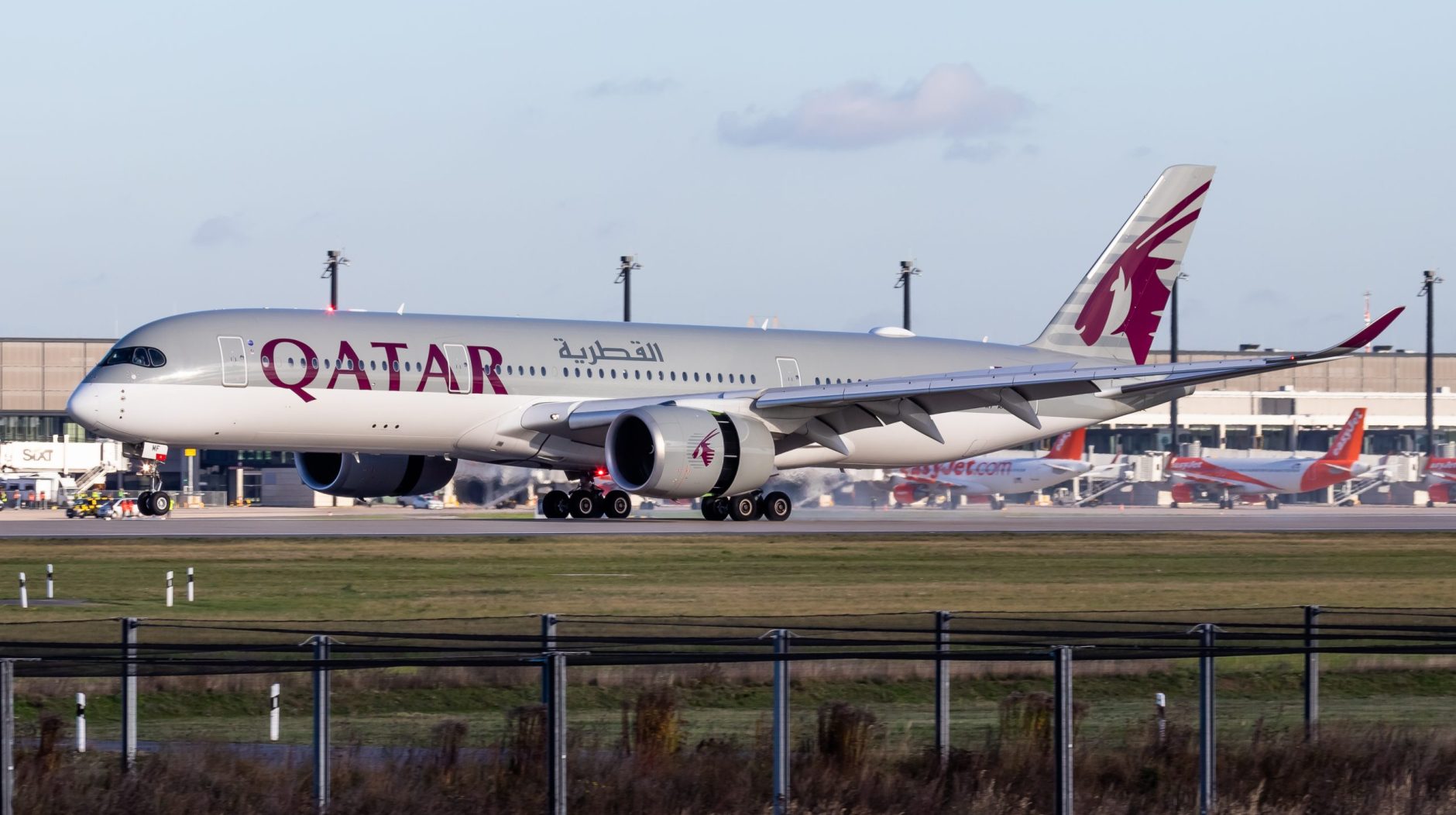 Qatar Airways A350-900 A7-AMF touching down on runway 25L at Brandenburg Airport.