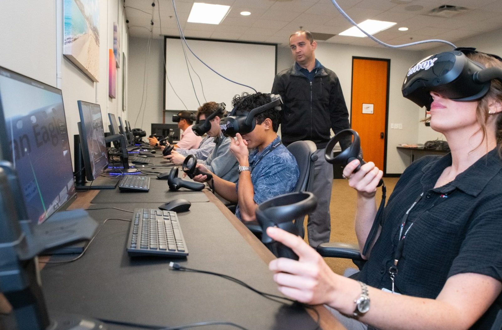 Trainees using a VR headset to practice skills they will need as pilots.