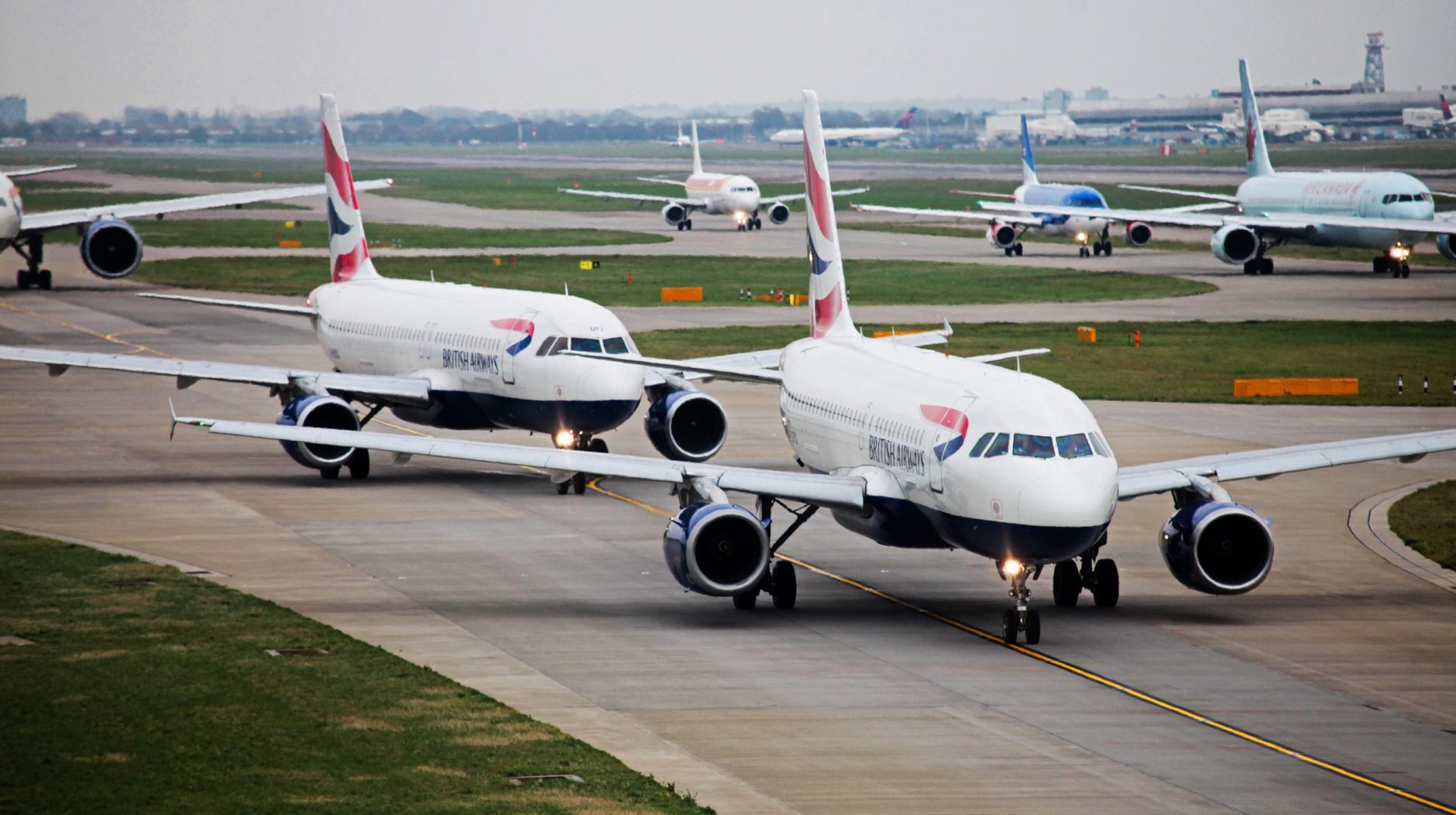 British Airways A319s taxi at London Heathrow.