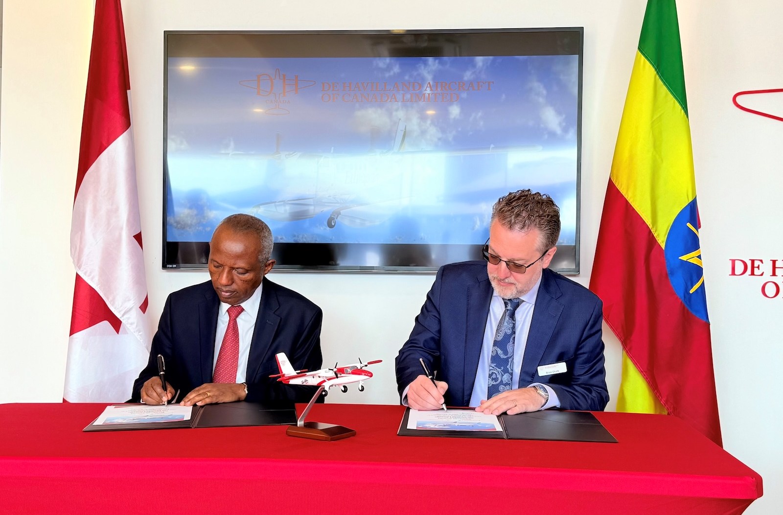 Ethiopian Airlines executives sign deal for new Twin Otter aircraft.