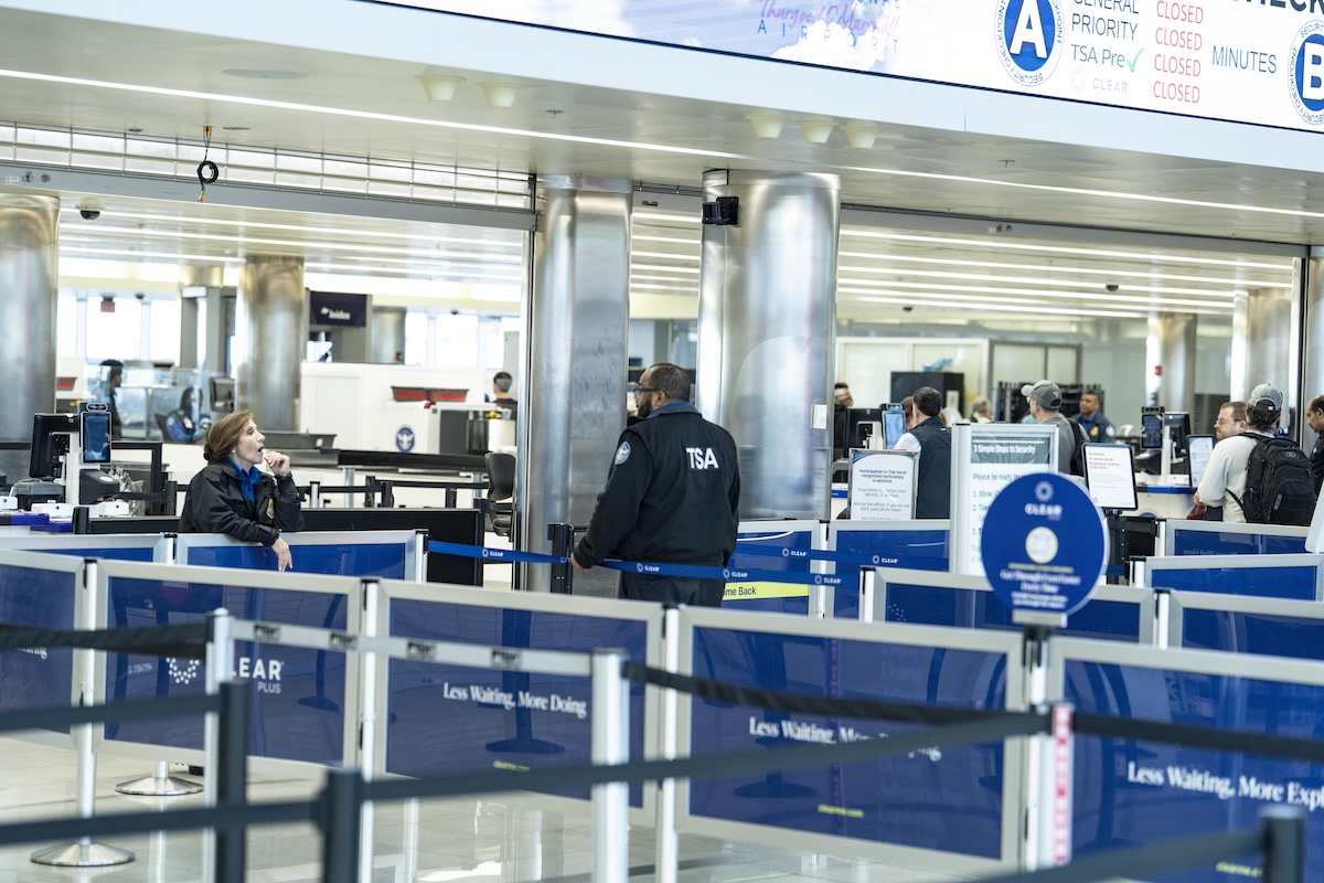 TSA officer stands in a checkpoint